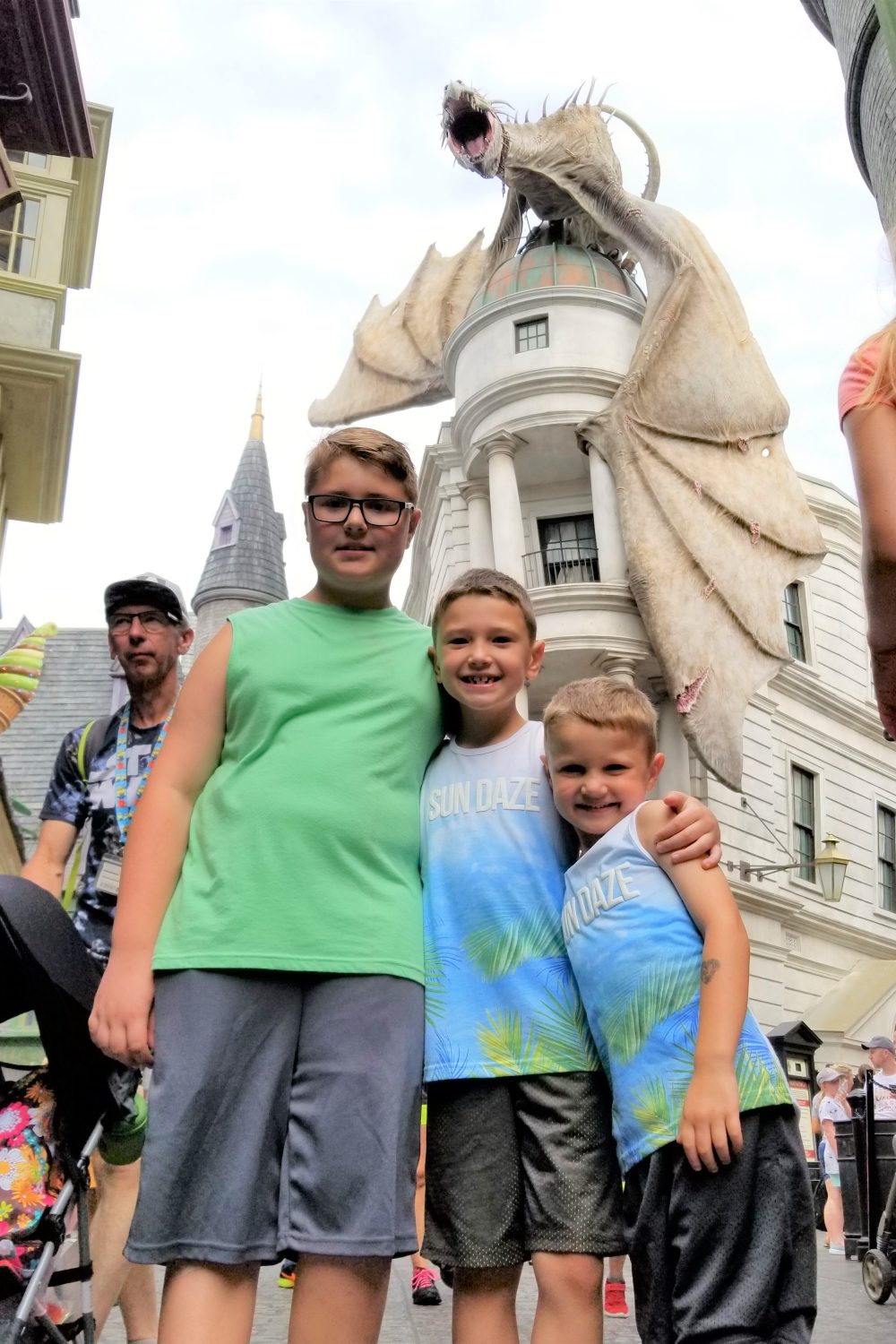 Three kids posing in front of the dragon In Diagon Alley at Universal Studios Orlando