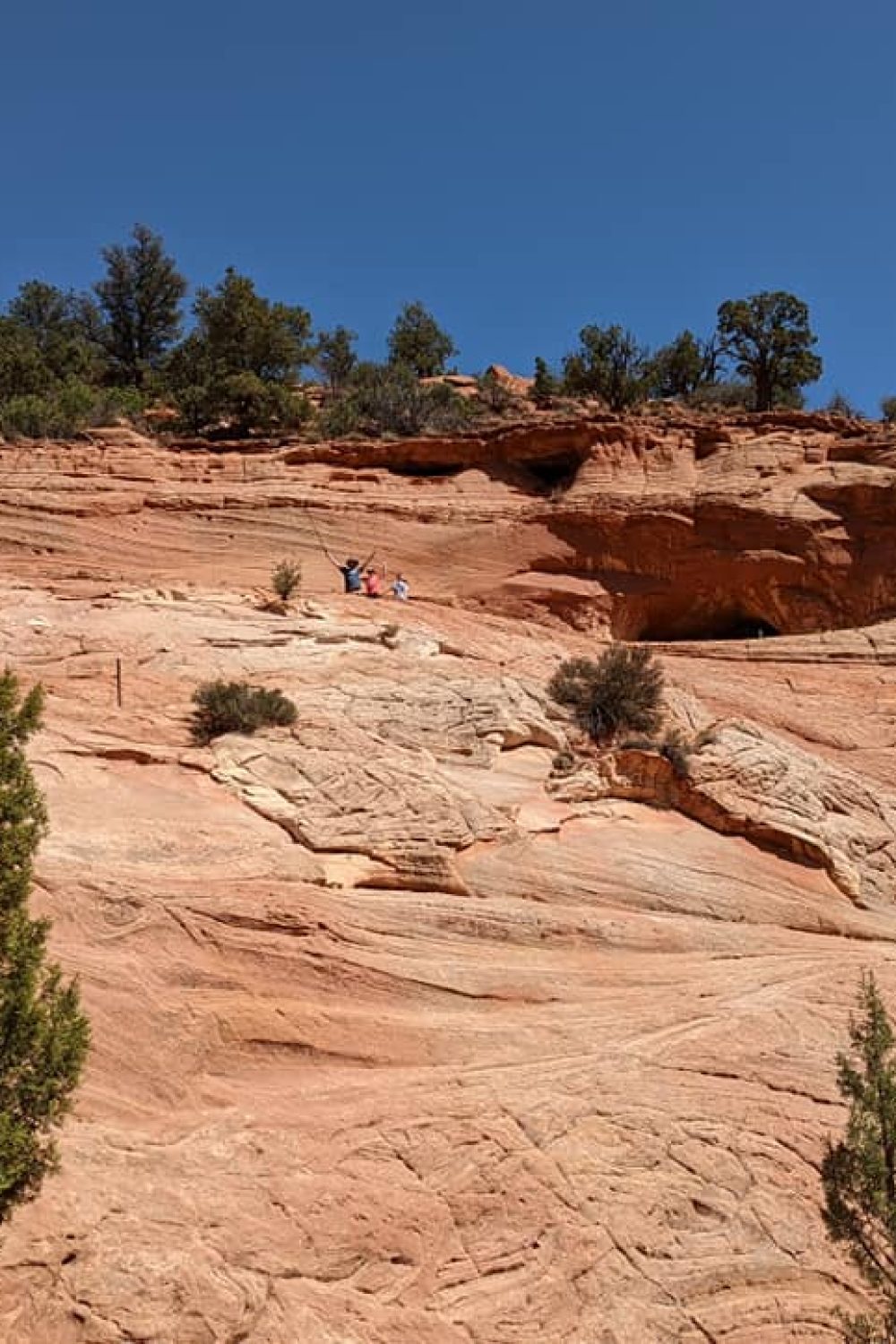 Kids and husband at the top of the Sand Cave after climbing the rocks