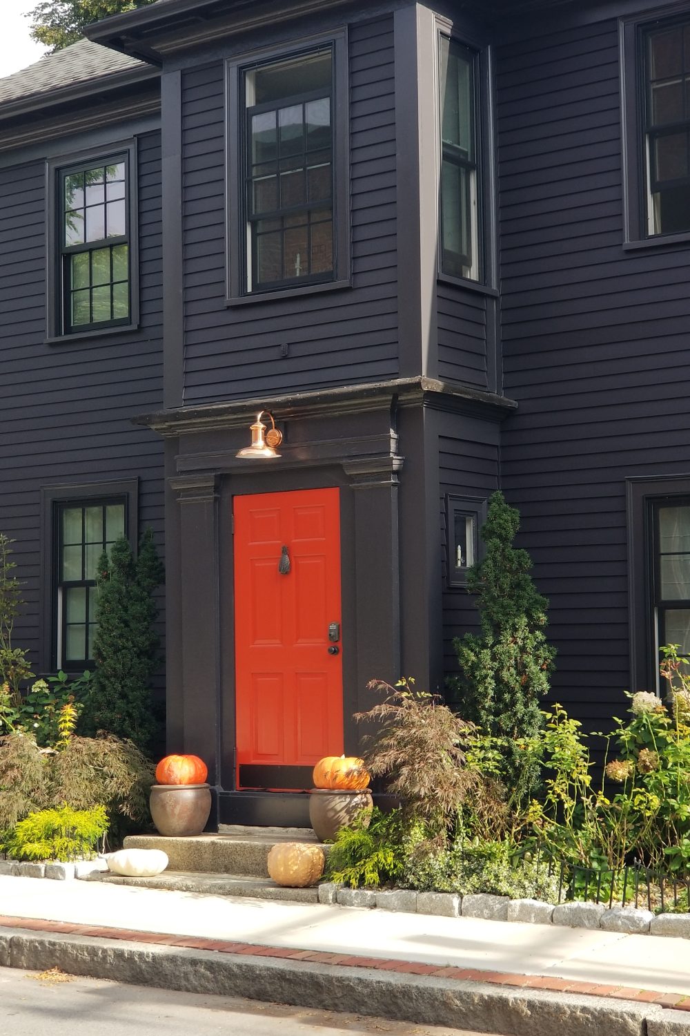 Black house with an orange door in Salem, MA
