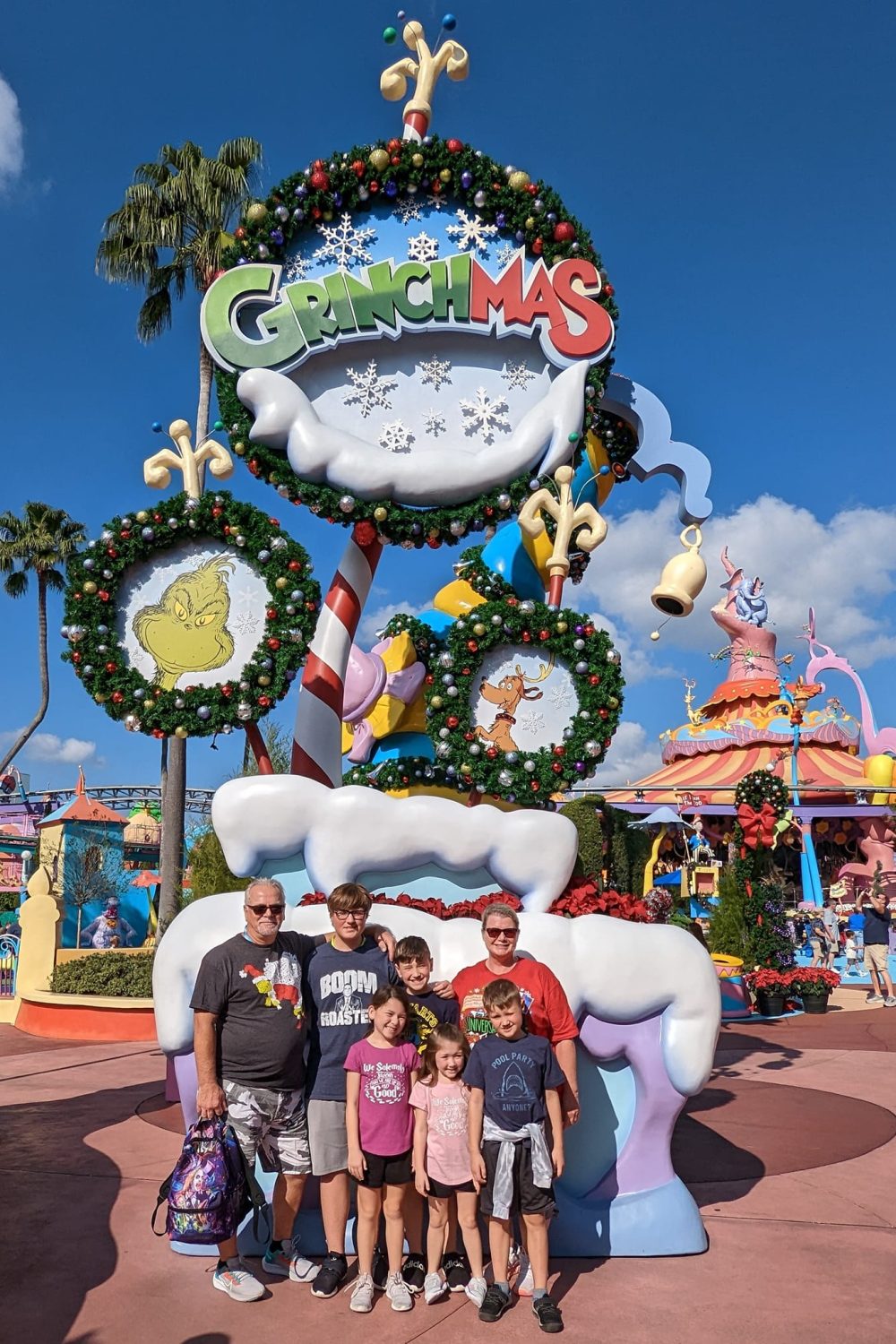 Kids with family in Seuss landing decorated for Christmas.