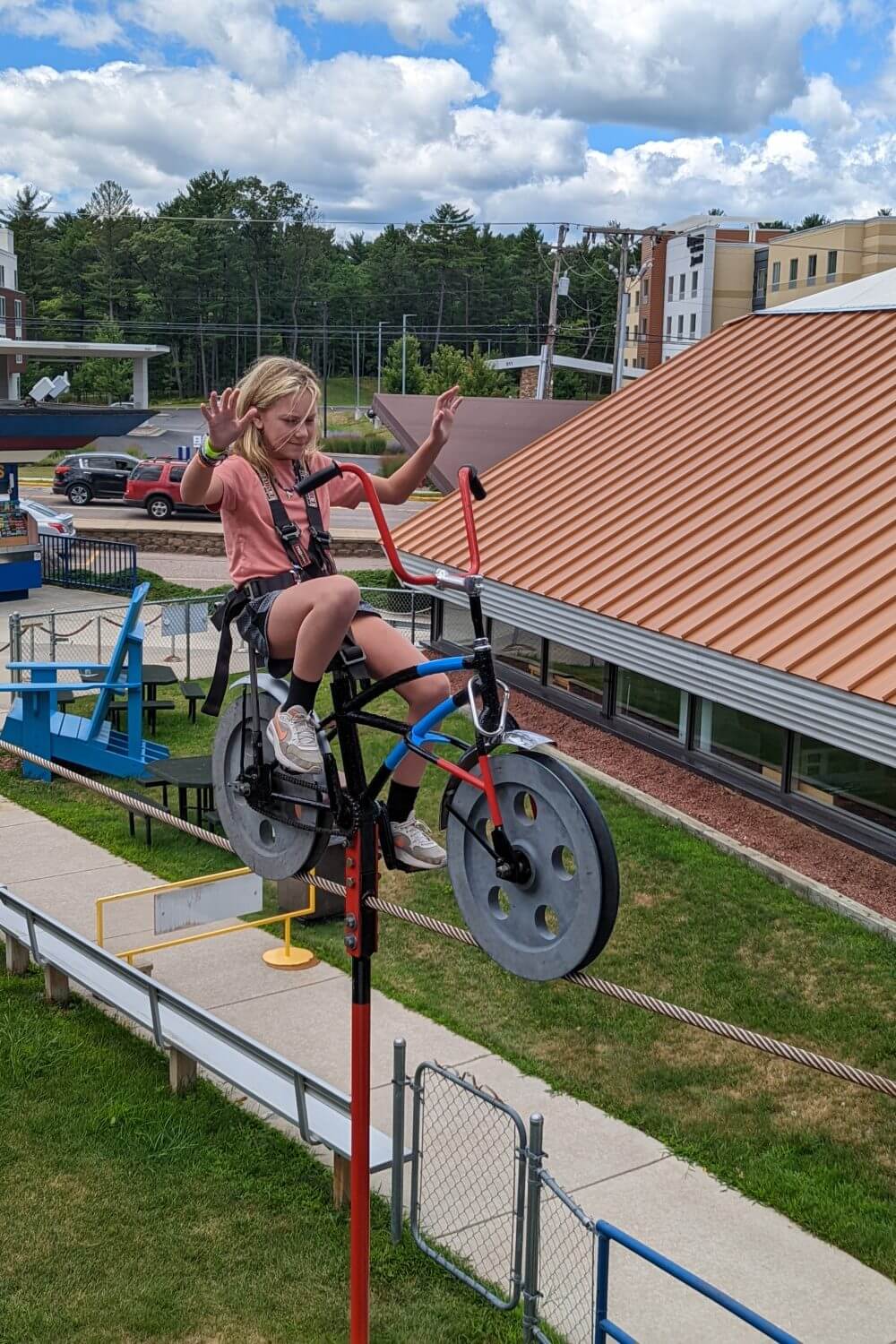Riding a bike on a rope at Tommy Bartlett Exploratory in Wisconsin Dells
