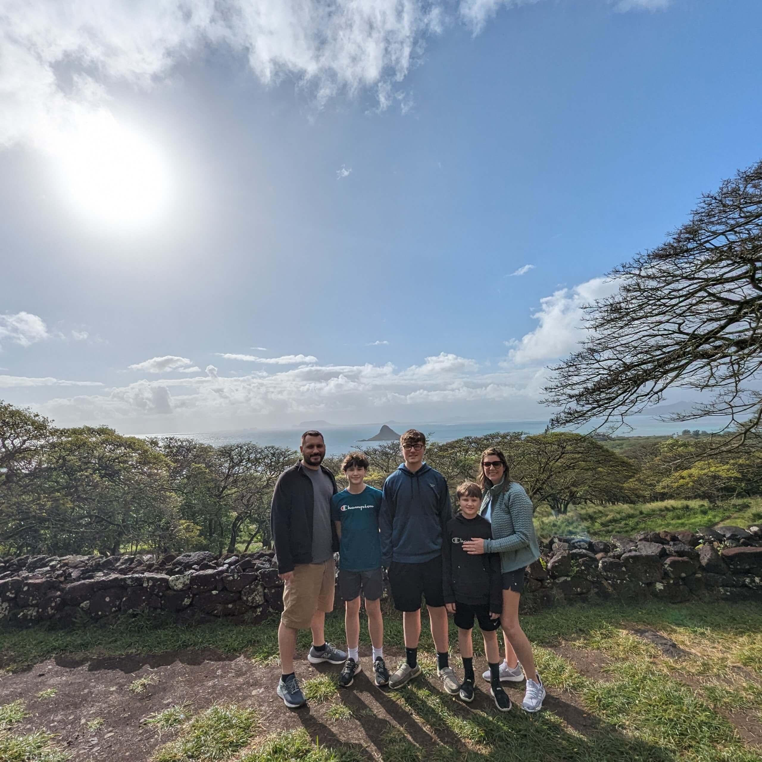 Kualoa Jungle Tour, family photo with Chinaman's Hat in the background