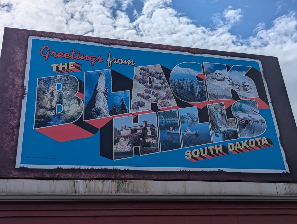 Mural with a post card showing the Black Hills of South Dakota