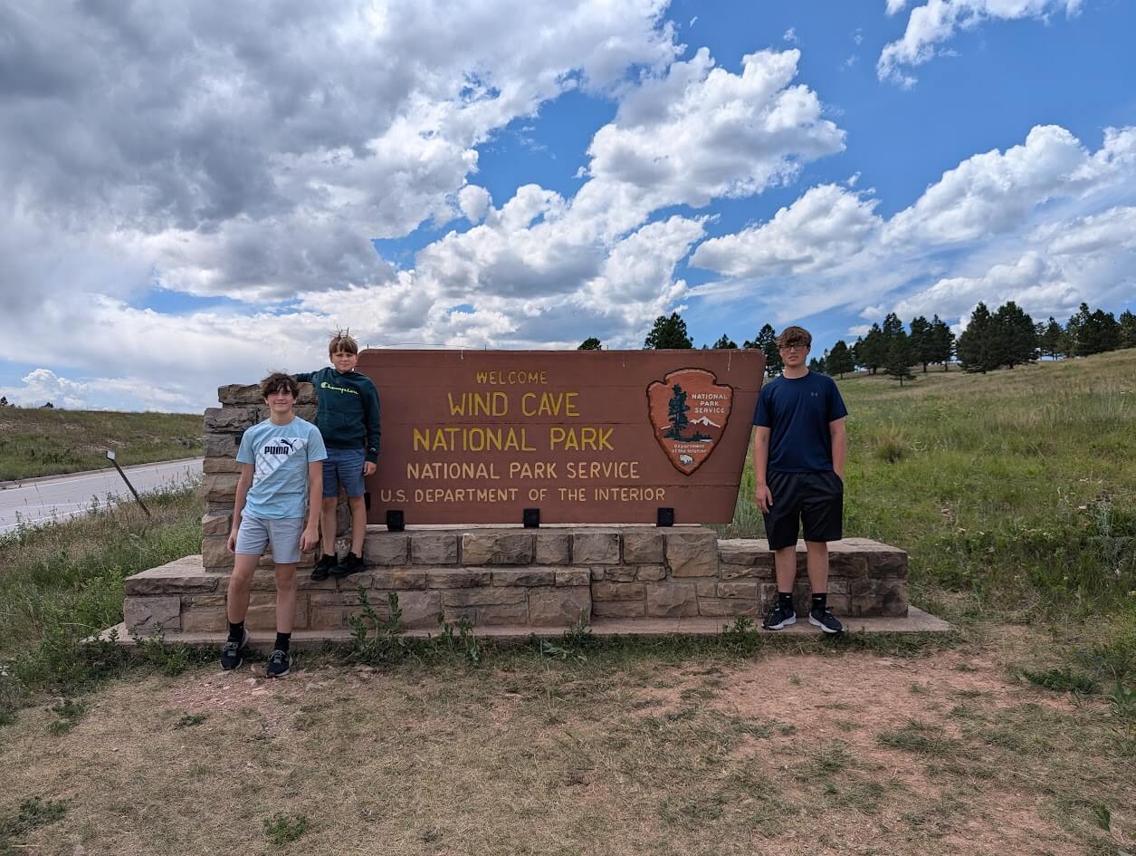 Our boys in front of the Wind Cave National Park sign