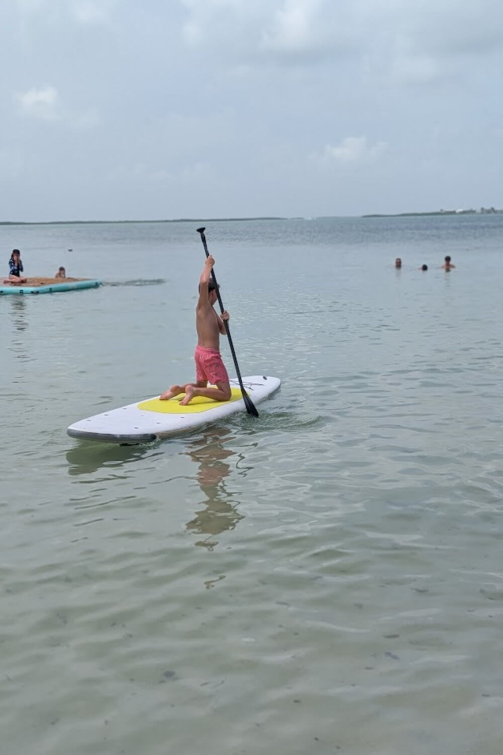 Our son trying the stand up paddle board