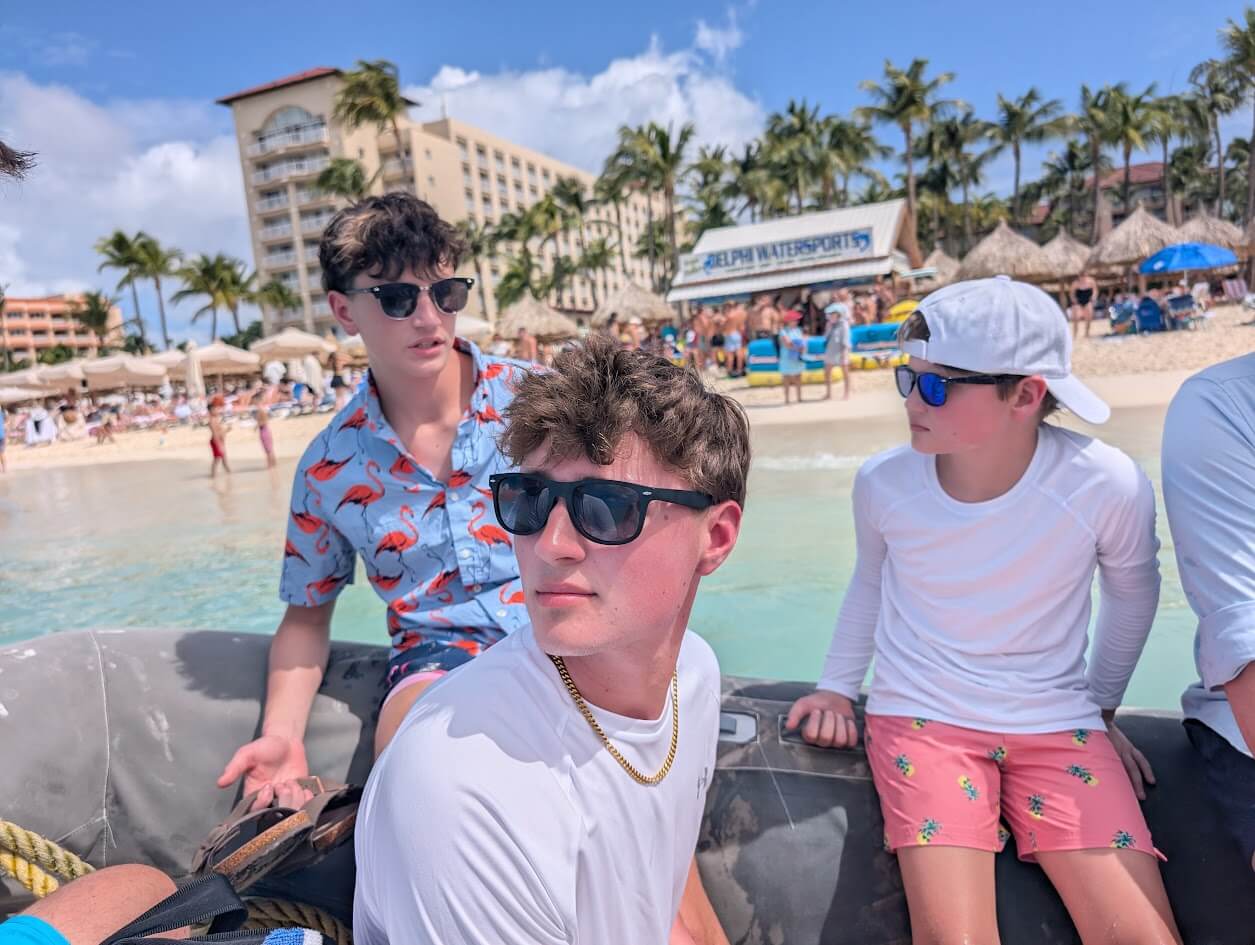 Our boys waiting to head to our snorkel tour with Palm Beach in the background